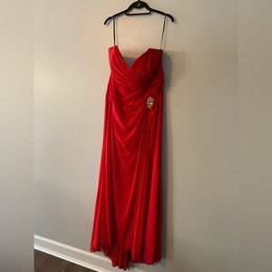 Beautiful Strapless Red Gown with side slit and crystal broach at the waist.